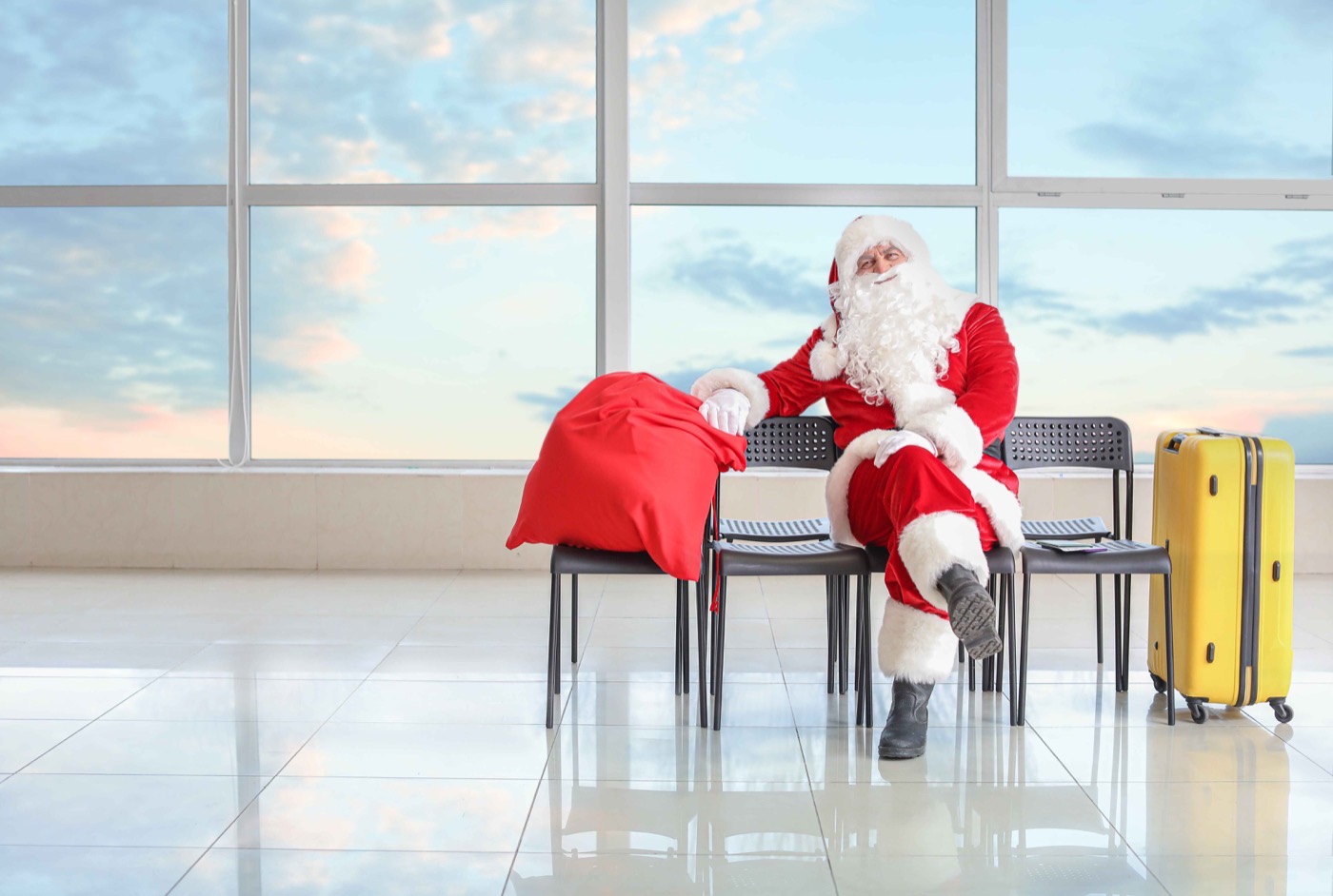 Santa Claus waiting in an airport lounge.